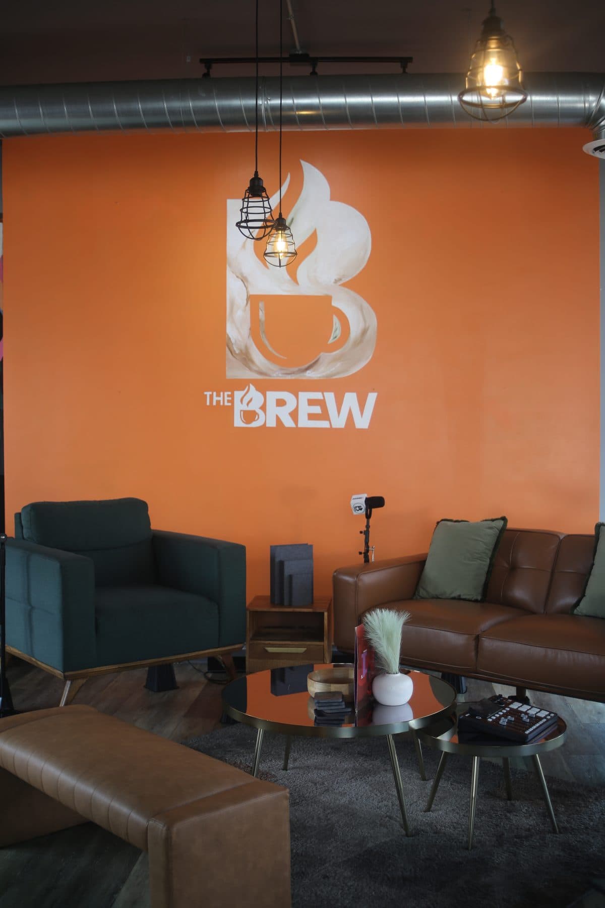 The painted Brew logo wall and podcast seating